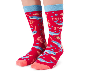 Women's Naughty Narwhal Socks - Red crew socks with blue narwhal and coral reef pattern, handmade Canadian gift by Uptown Sox.