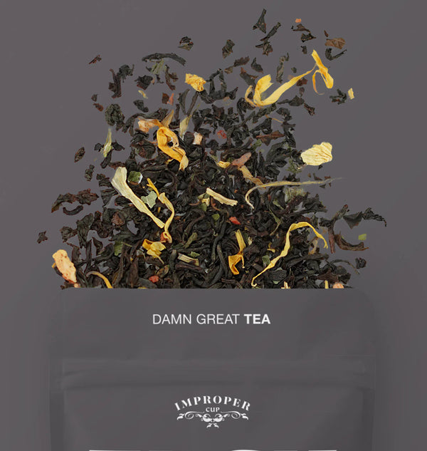 The top quarter of the bag is visible with a blend of tea leaves spilling out of the bag