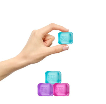 NeeDoh Nice Ice Baby - Hand holding blue NeeDoh Nice Ice Baby squishy toy, stacked with purple, light blue, and pink unique handmade Canadian gifts.