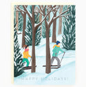 Two people cross-country ski through a wintry forext. At the bottom of the card reads 