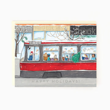 Toronto Streetcar Holiday Card | The Paperhood - Handmade Canadian holiday card featuring a red Toronto streetcar with festive passengers, unique gift design.