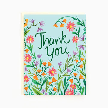 Thank You Wildflower Greeting Card | The Paperhood - Handmade greeting card with colorful wildflowers and green "Thank You" text on light blue background.
