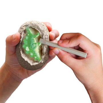 I dig it! Dinos - Glow-in-the-dark T. Rex Dino Egg - Hands excavating a green glow-in-the-dark T. Rex dino egg, unique handmade Canadian gift toy.
