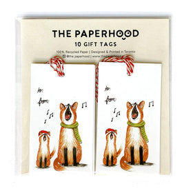 Two gift tag sets next to each other depicting a small and large fox singing while wearing a red Santa hat and a green scarf.