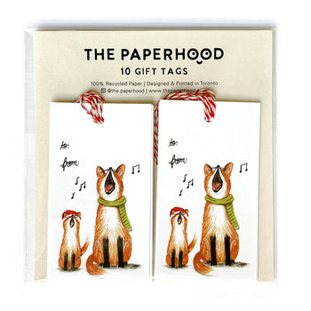 Two gift tag sets next to each other depicting a small and large fox singing while wearing a red Santa hat and a green scarf.