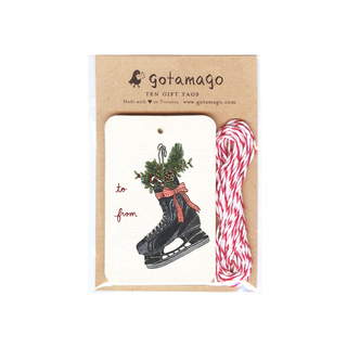 A white gift tag with a black skate filled with holly, a pinecone and a candy cane next to red font reading 