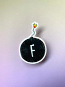A sticker of a bomb with the letter "F" in the middle