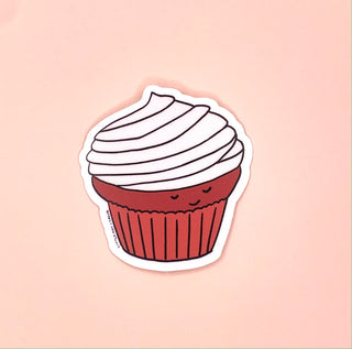 A sticker shaped like cupcake. The cupcake has white icing and a red cake base