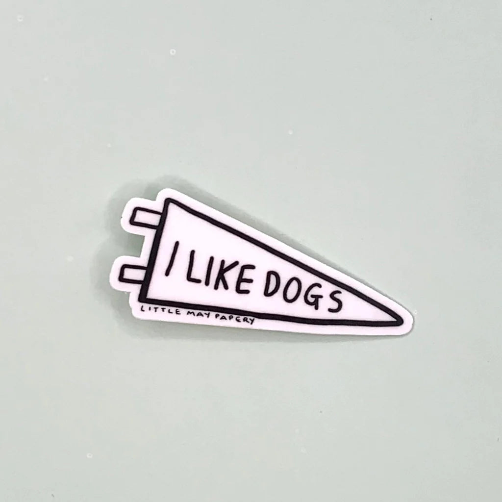 A sticker of a white triangular flag reading "I like dogs"