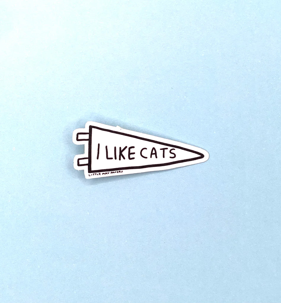 A sticker in the shape of a triangular flag with the text "I like cats"