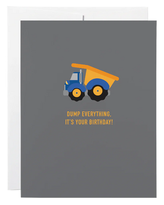 A dark blue card with a picture of a dump truck and the words 