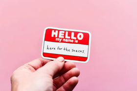 A vinyl sticker of a name tag that says "Hello My Name is here for the snacks"