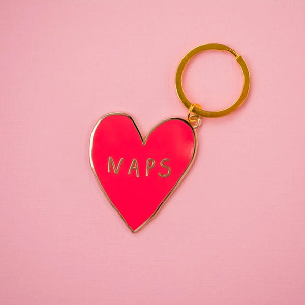 A keychain of a red heart outlined in gold with the word 