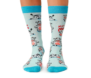 Women's Moody Cow Socks - Light blue knee-high socks featuring whimsical moody cow illustrations, handmade Canadian gift design.