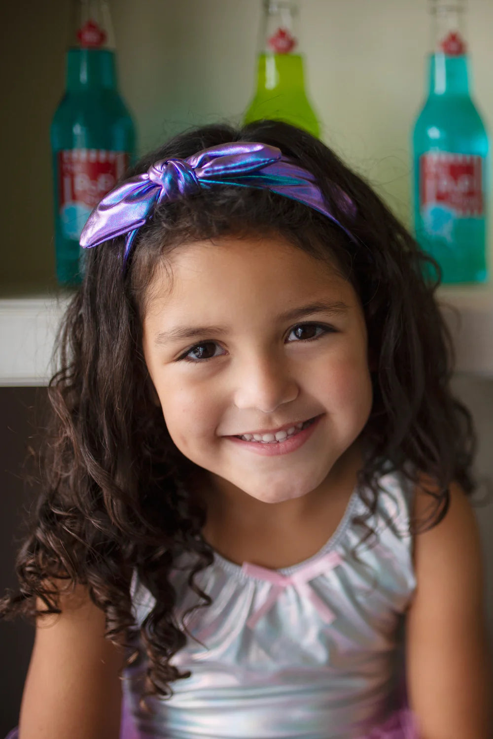 A girl wearing the Midnight Metallic Headband