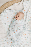 A baby in the ice hockey muslin swaddle