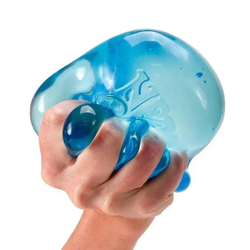 NeeDoh Nice Berg - Blue translucent handmade NeeDoh Nice Berg stress toy squeezed in hand, unique Canadian gift.