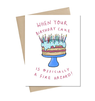 A white card with an illustrated blue and pink cake overflowing with candles. In pink reads 