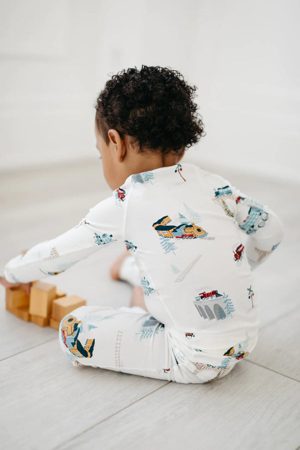A baby wearing All Aboard 2-pc Pajama Set (LouLou Lollipop)