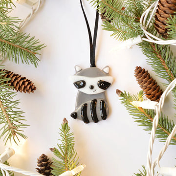 Raccoon Ornament - Handmade Canadian raccoon ornament in gray and black as a unique Christmas gift hanging with pinecones and green pine.