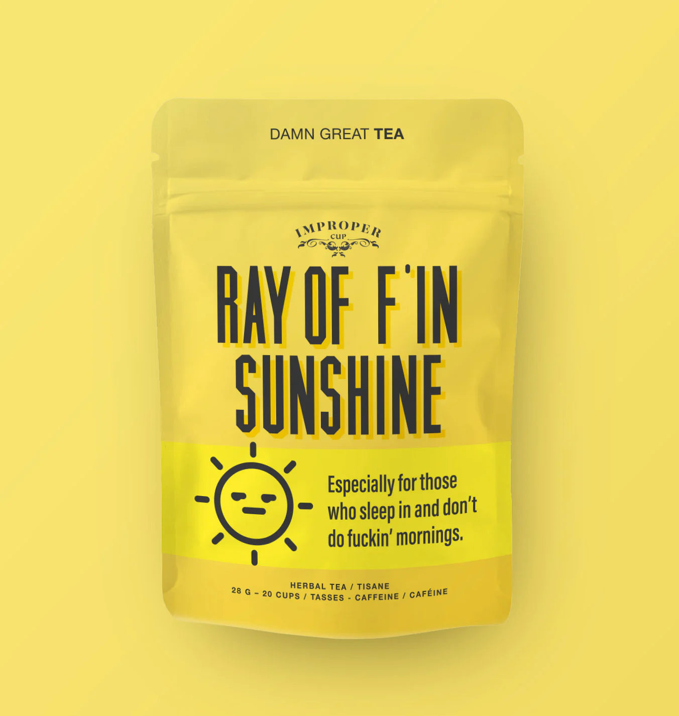 A yellow bag with black text reading "RAY OF F'IN SUNSHINE" with an illustration of a sun with a straight face on