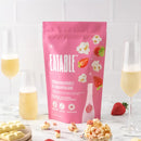 Strawberries & Champagne - Gourmet Popcorn - Pink package of Strawberries & Champagne gourmet popcorn with popped popcorn and champagne glasses, handmade Canadian gift.