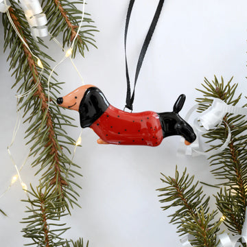 Dachshund Christmas Ornament - Handmade Canadian black and brown dachshund Christmas ornament wearing a red sweater with black polka dots, hanging on a.