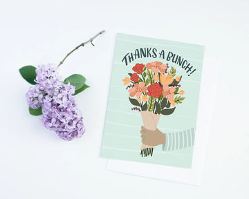 Thank You Flower Card - Thank You card with illustrated hand holding colorful bouquet and "Thanks a Bunch!" text on pastel green background.