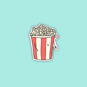 A red and white striped popcorn bucket filled with popcorn with a smiley face and stick arms