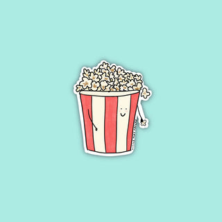 A red and white striped popcorn bucket filled with popcorn with a smiley face and stick arms