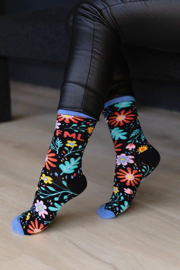 Women's FML Socks - Black crew socks with colorful floral patterns and "FML" text, handmade Canadian gift.