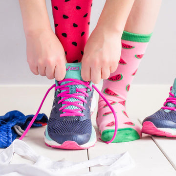 Women's Inside Out Watermelon Socks - Pair of unique handmade Canadian socks with pink watermelon designs worn with navy running shoes, perfect gift idea.