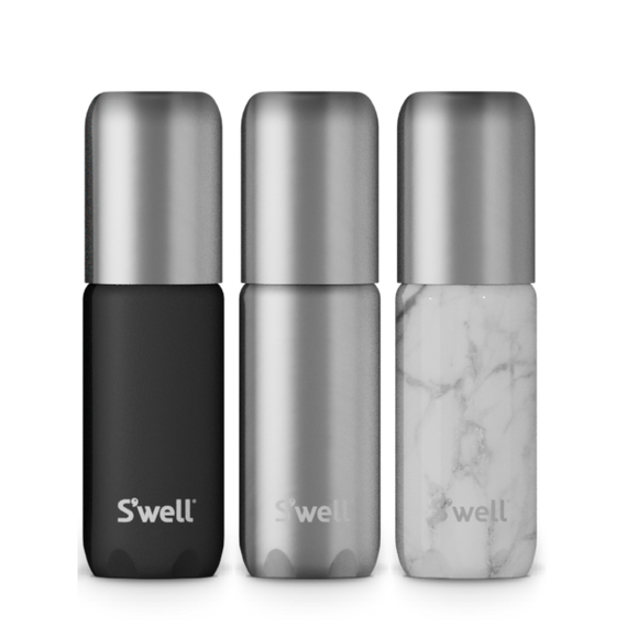 Onyx Travel Bottle Set - Set of three sleek travel bottles with matte black, brushed silver, and white marble finishes, each featuring a rounded.