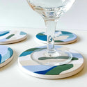 Coasters shown up close with a wine glass on them