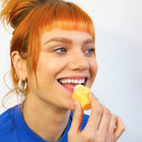 GIFT SET 3 Pack Lip Balm FALL EDITION - Handheld yellow cylindrical lip balm with smooth texture, applied by smiling woman with red hair and blue top.