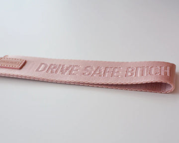 Drive Safe Bitch Wristlet - Light pink handmade wristlet with embossed "Drive Safe Bitch" text, unique Canadian gift accessory.