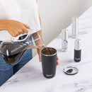 Onyx Travel Bottle Set - Matte black insulated travel bottle with silver lid and removable lid coaster placed on white marble counter, accompanied by