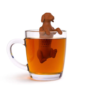 Hot Dog Tea Infuser - Handmade Canadian hot dog tea infuser hanging in clear glass mug with amber tea, unique gift idea.