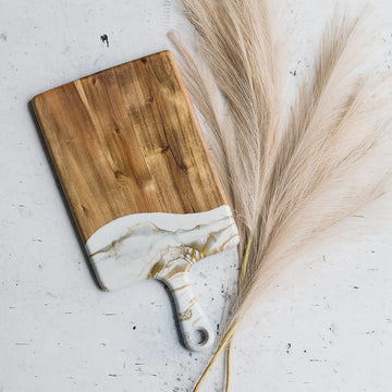 Lynn & Liana Medium Cheeseboard (8 x 16") - Medium rectangular cheeseboard with natural wood grain and white resin handle featuring gold veins, handmade Canadian gift.