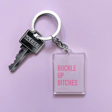 Buckle Up Bitches Keychain - Clear rectangular keychain with bold pink text "Buckle Up Bitches," handmade Canadian gift accessory.