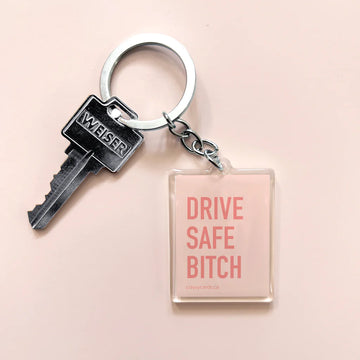 Drive Safe Bitch Keychain - Rectangular handmade Canadian keychain with pink background and "Drive Safe Bitch" text in bold letters, paired with a.