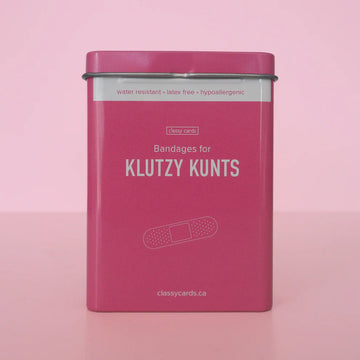 Klutzy Kuntz Bandages - Pink metal tin of Klutzy Kuntz bandages, a unique Canadian handmade gift with cheeky branding.
