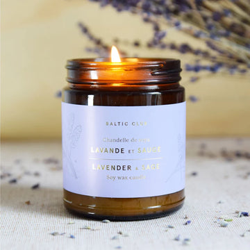 Lavender & Sage Soy Candle - Burning handmade Canadian soy candle in amber glass jar with lavender and sage scent, unique gift.