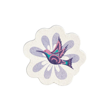 Eco Sponges - White flower-shaped sponge with purple petal designs and a colorful hummingbird illustration in the center.