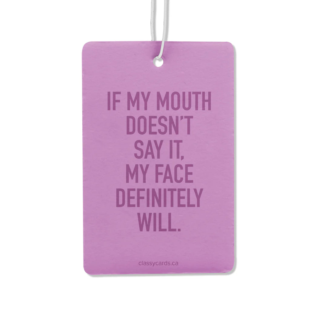 A purple air freshener with the words "If my mouth doesn't say it, my face definitely will"