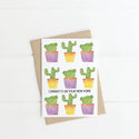 A white card with a variety of cacti and the words 