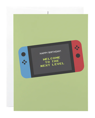 A sage green card with a picture of a nintendo switch and the words 
