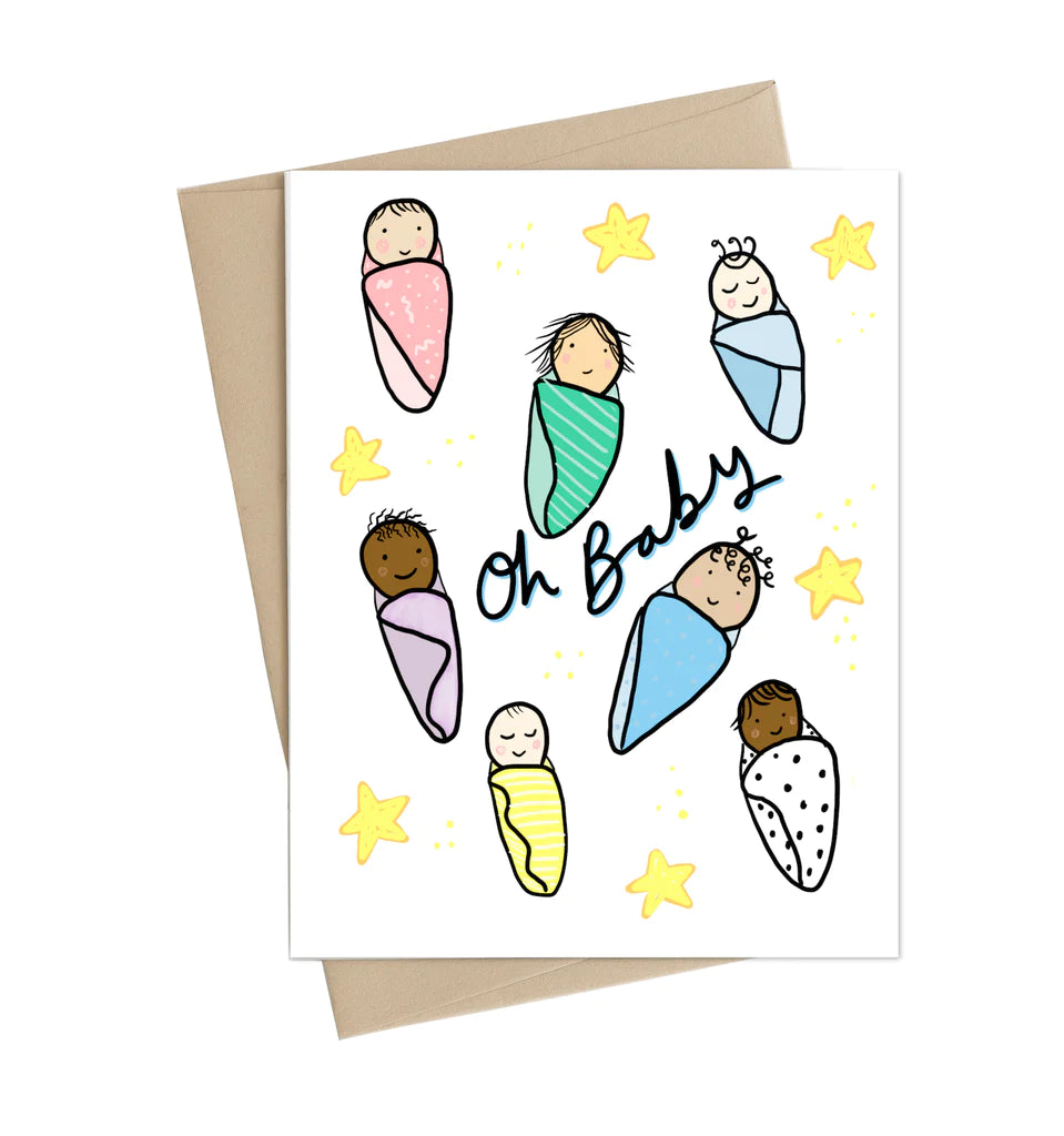 A white card with 7 different babies and 6 stars scattered. In the middle in black text reads "Oh Baby"