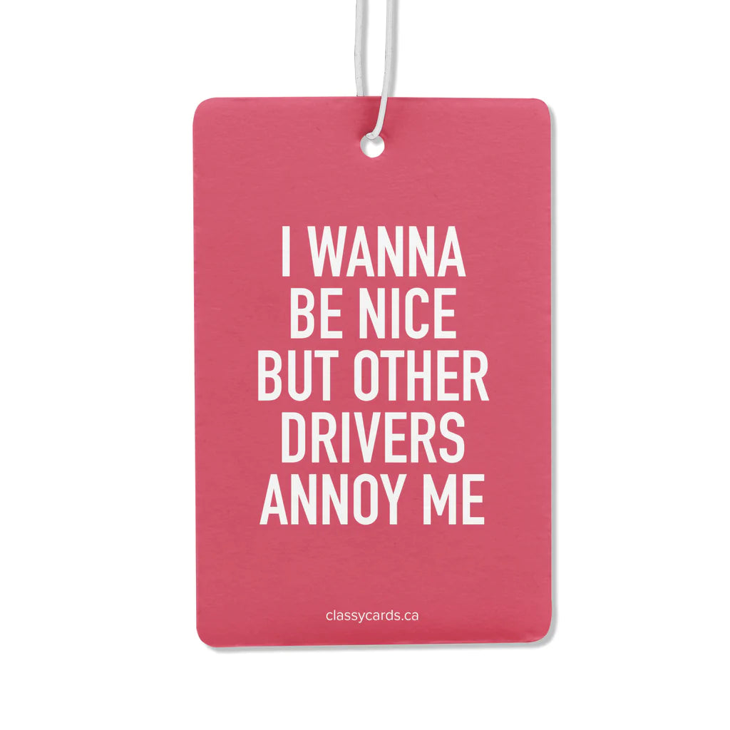 A pink air freshner with the words "I wanna be nice but other drivers annoy me"