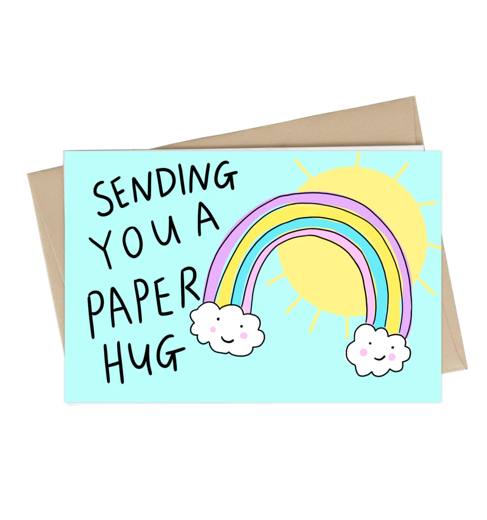 A sky blue card with a rainbow and the Sun illustrated next to black text reading "Sending you a paper hug"